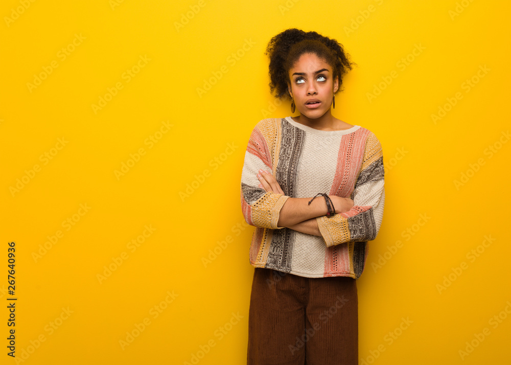 Young black african american girl with blue eyes tired and bored Young black african american girl with blue eyes tired and bored