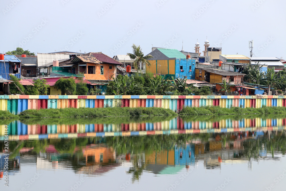 Rainbow village in Indonesia, colorful houses and colorful dam along the canal of slum.
