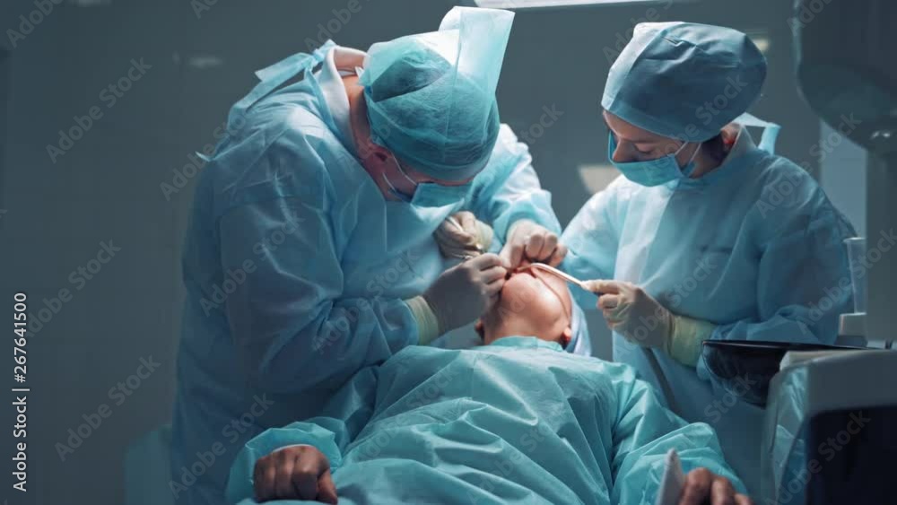 Dentist in medical clothes is treating a patient in a dental office. Orthodontist works with an assistant. The client is treating his teeth. Dentist in medical clothes is treating a patient in a dental office. Orthodontist works with an assistant. The client is treating his teeth.