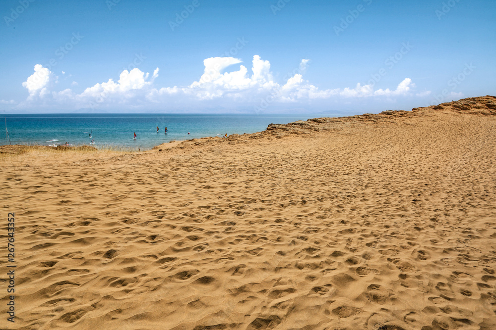 Beach background of free space and summer day. Hot yellow sand and blue sky. 