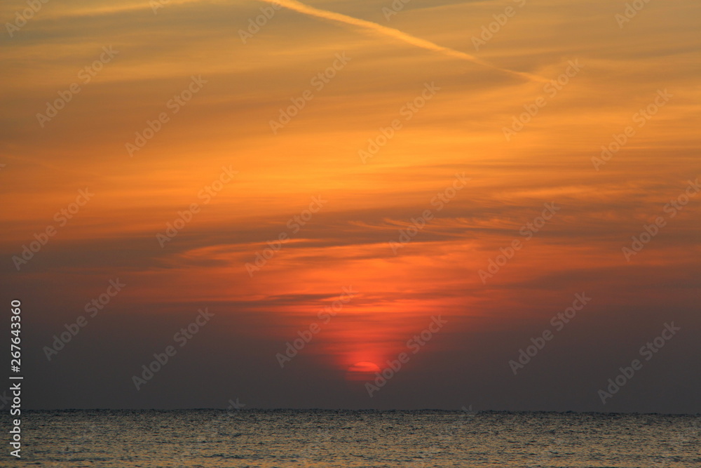  Dawn on the beach. Sun and sea in the early morning. Beautiful seascape.