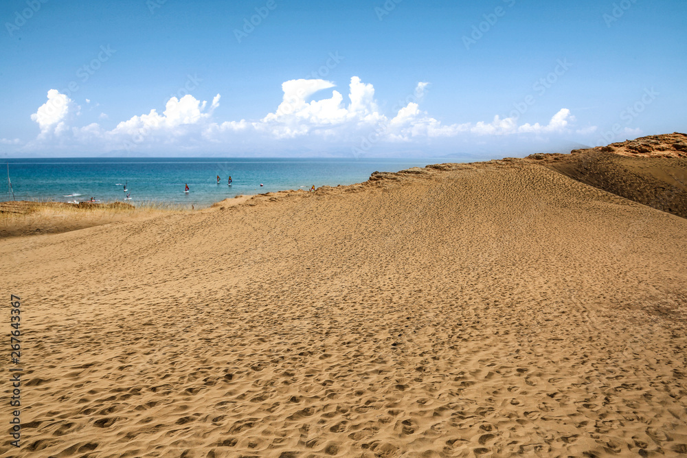 Beach background of free space and summer day. Hot yellow sand and blue sky. 