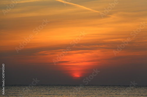  Dawn on the beach. Sun and sea in the early morning. Beautiful seascape.