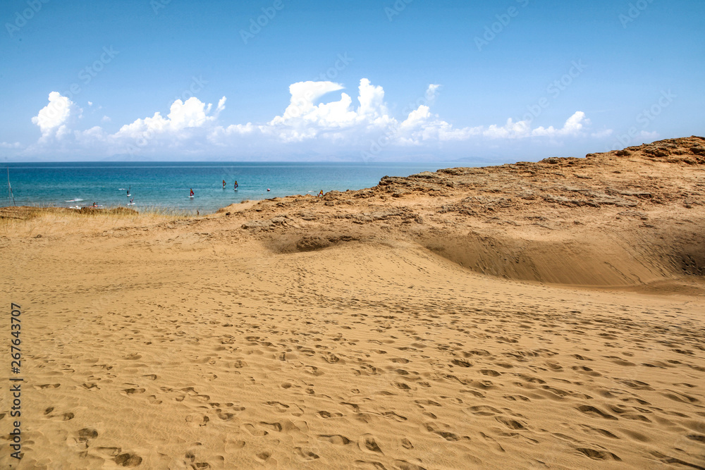 Beach background of free space and summer day. Hot yellow sand and blue sky. 