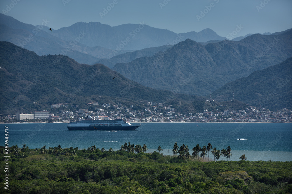 Cruise ship leaving Banderas Bay Puerto Vallarta Mexico with Sierra Madre mountains