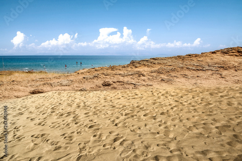 Beach background of free space and summer day. Hot yellow sand and blue sky. 