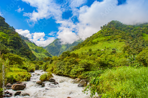 South America. Ecuador. Ecuadorian Andes with tops covered with clouds. Rough Pastaza river at the foot of the mountains. Mountain landscape of Ecuador. Extreme tours in Ecuador.