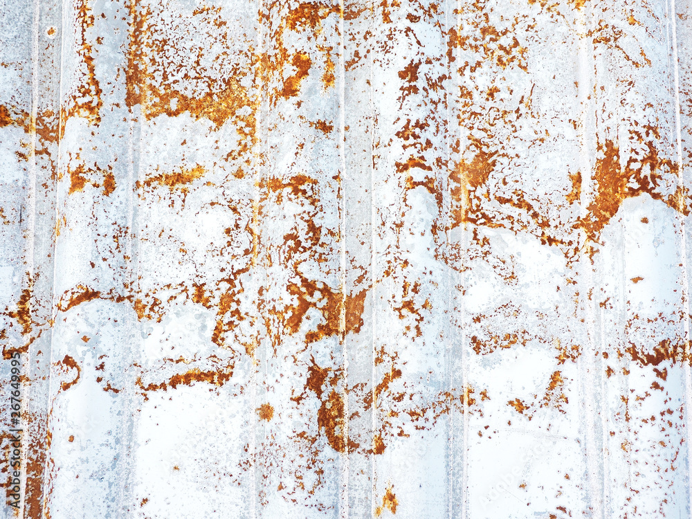 Fog and texture corrugated sheet of iron with rust appearing through the white paint...