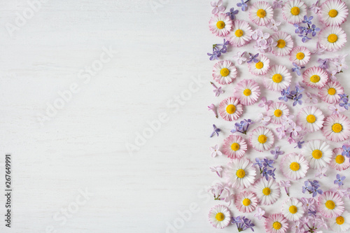 Pink daisies and lilac flowers on wooden background