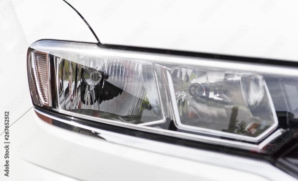 white car head lights close up