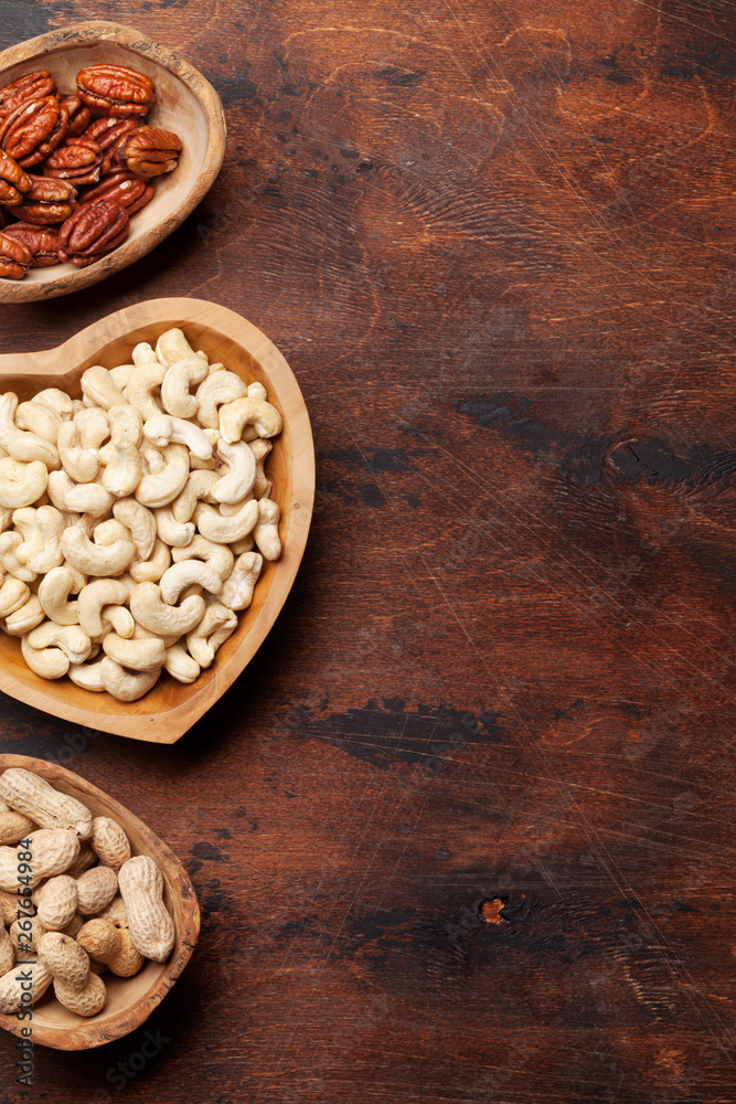 Various nuts selection on wooden table Various nuts selection on wooden table