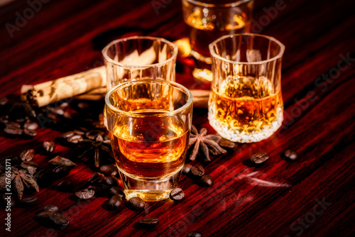 Fototapeta Naklejka Na Ścianę i Meble -  Brandy or liquor,Set of strong alcoholic drinks in glasses and shot glass on dark wood background