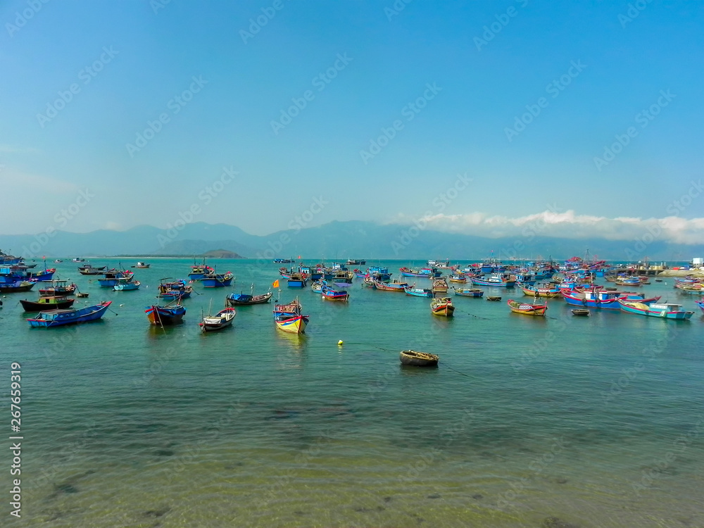Fishermen boats in the sea in Vietnam against the backdrop of the mountains