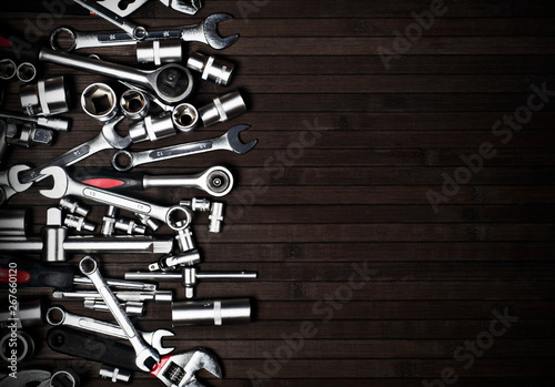 many spanners on a wooden black background