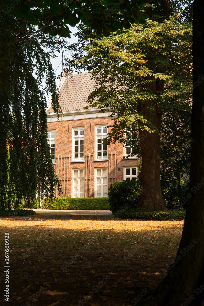 building and trees in shadow,  public park Stadhuistuin, Tiel, The Netherlands
