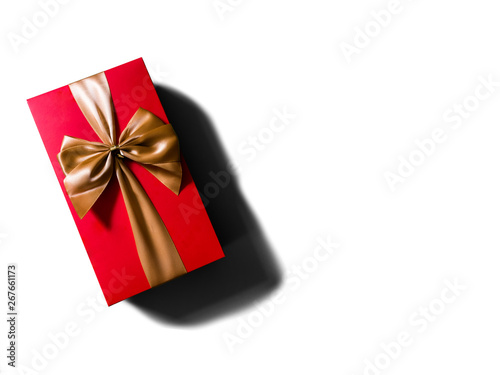 Concept or idea of flat view of red gift box with gold ribbon or bow.
