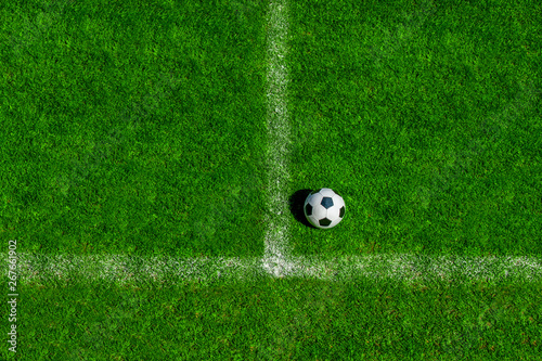 soccer ball classic in black and white on penalty spot on green artificial turf