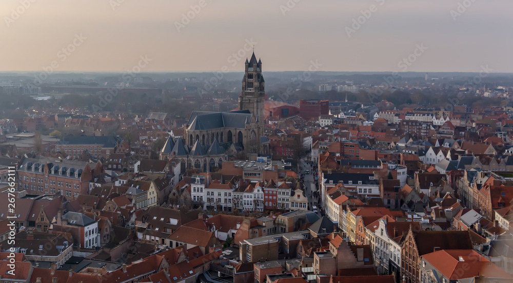 Fantastic Bruges city skyline with red tiled roofs and Saint-Salvator Cathedral tower in winter day. View to Bruges medieval cityscape from the top of the Belfry Tower.