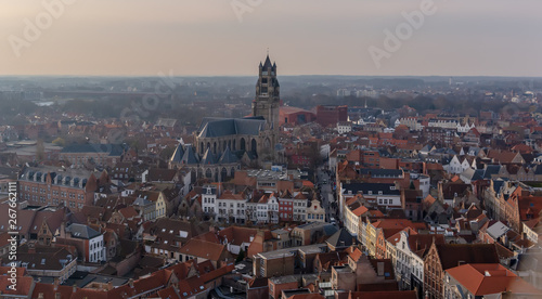 Fantastic Bruges city skyline with red tiled roofs and Saint-Salvator Cathedral tower in winter day. View to Bruges medieval cityscape from the top of the Belfry Tower.
