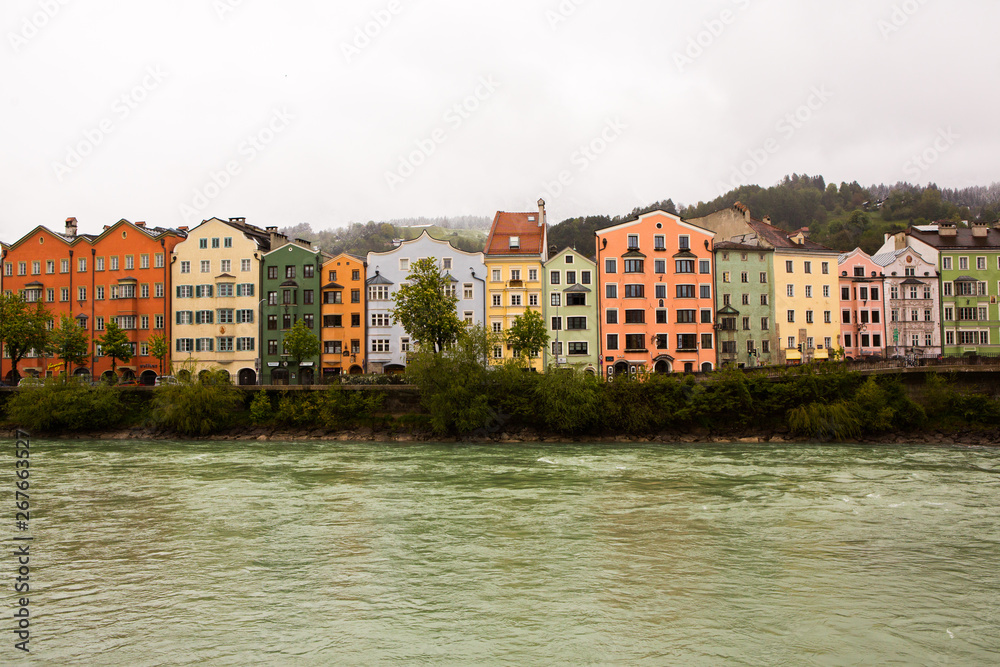 Colorful houses in Innsbruck with Inn river in the background. Beautiful view of the historic city center of Innsbruck.