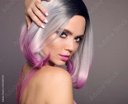 Girl Portrait of Ombre bob short hairstyle. Beautiful hair coloring woman. Trendy puprle haircut. Blond model with short shiny haircuts isolated on grey Background. Makeup. Beauty Salon.