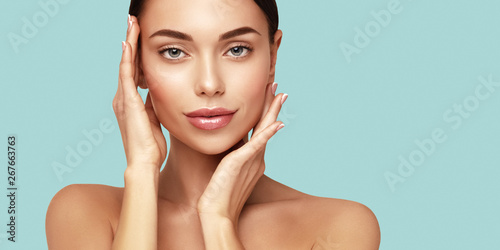 Skin care,Beauty treatment and spa concept. Attractive model with brown hair and  Clean Fresh Skin touch own face