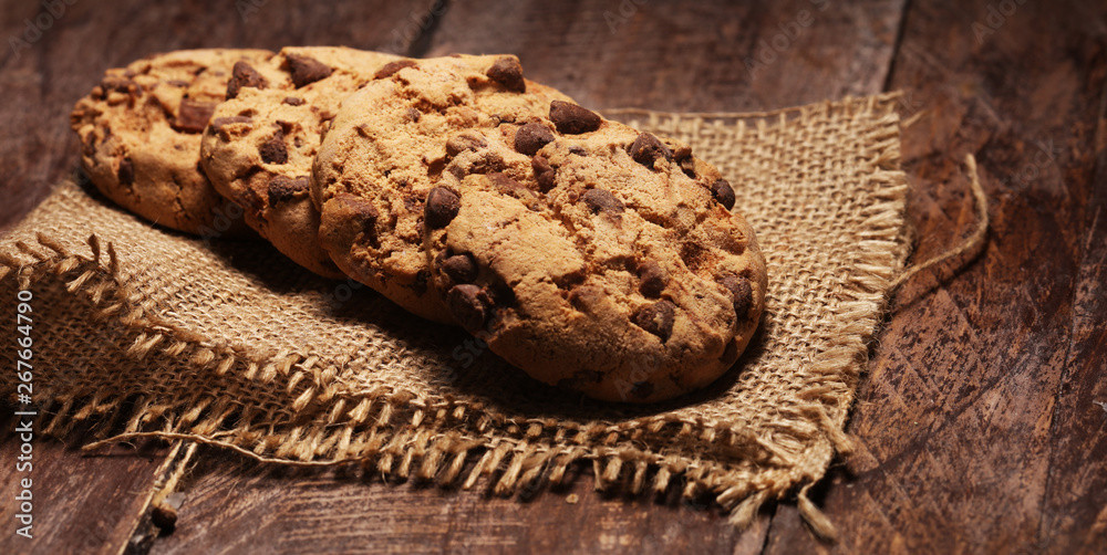 Fototapeta premium Chocolate cookies on wooden table. Chocolate chip cookies shot very delicious