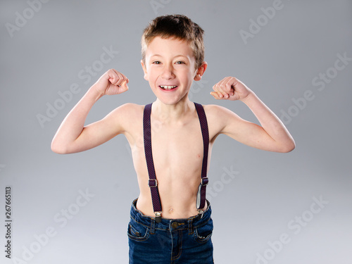 Thin boy showing muscles