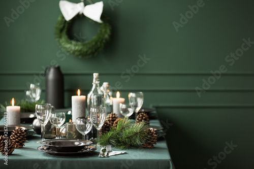 Elegant table set for christmas dinner, copy space on empty green wall photo