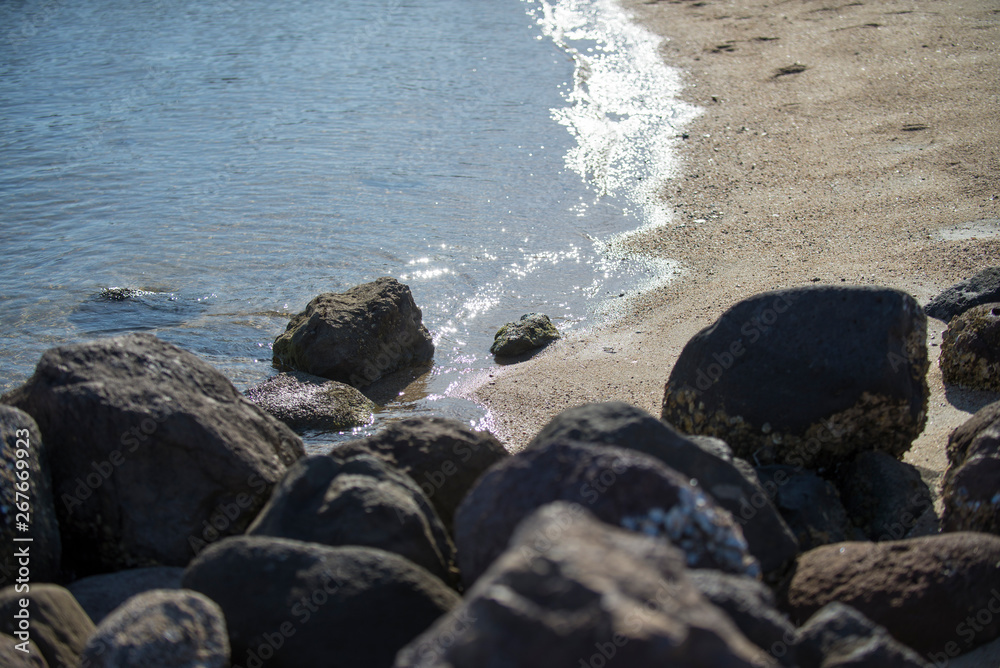 Rocks on the beach, near the ocean waves, in La Paz, Baja California Sur. MEXICO