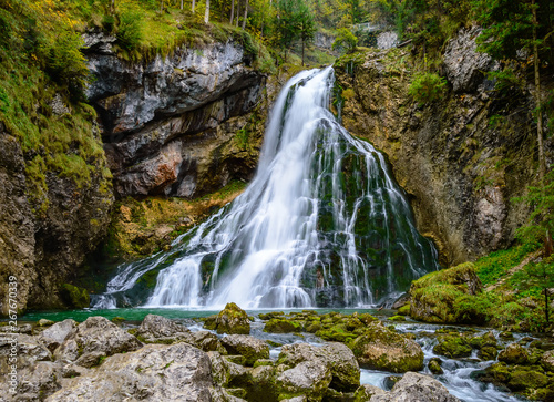 Gollinger Waterfall in Golling an der Salzach near Salzburg  Austria. Stunning view of cascade waterfall over mossy rocks in the Alps with long exposure