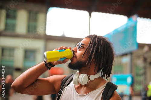 Young Afro handsome man having a drink
