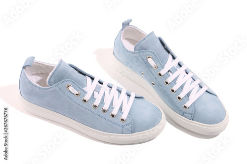 Real leather low top blue sneakers layout in white color. Isolated on white