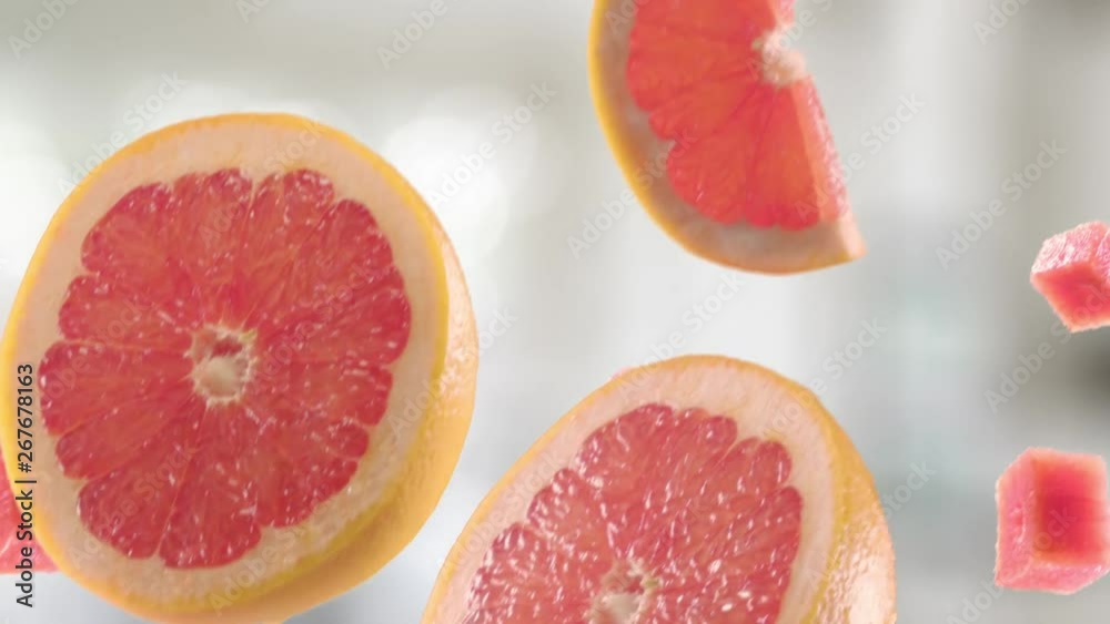 Grapefruit with Slices Falling on Kitchen Background Grapefruit with Slices Falling on Kitchen Background
