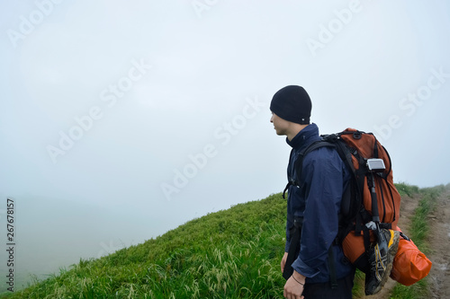The young guy on the top of the mountain. Bieszczady Mountains, Poland. Travel concept. 