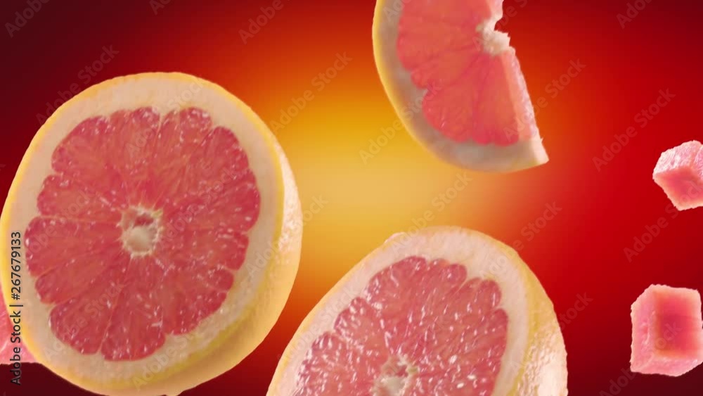 Grapefruit with Slices Falling on Red Background Grapefruit with Slices Falling on Red Background