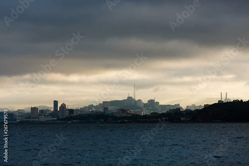 The coastline of Vladivostok from the sea. Vladivostok in inclement weather. The sea facade of Vladivostok.