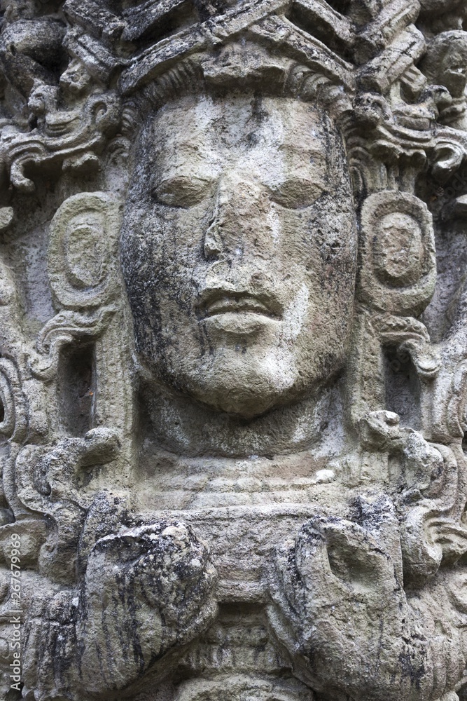 Mayan Face Carved in Stone Temple Building in World Famous Copan Ruins Archeological Site of ancient Maya Civilization, a UNESCO World Heritage Site in Honduras near Guatemala Border