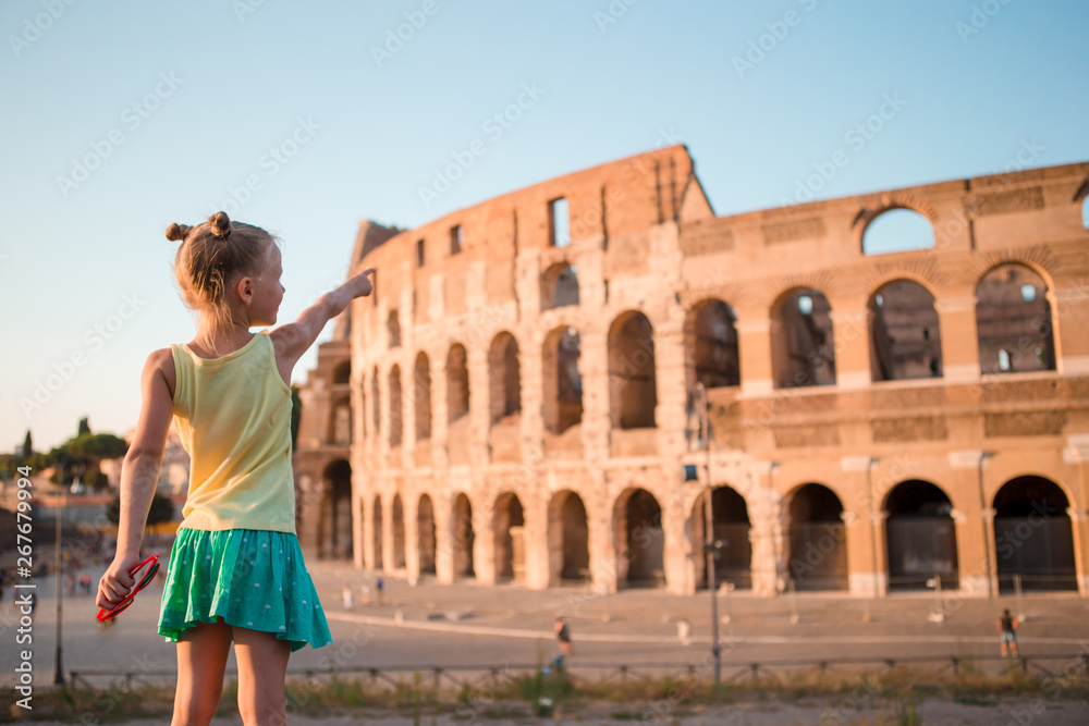 Young girl in front of Colosseum in rome, italy