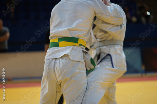 Brazilian jiujitsu fighters in a fight stand up wrestling at the tournament BJJ