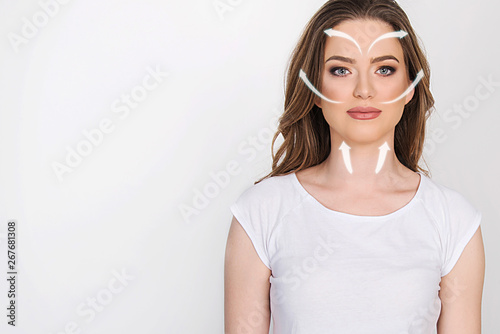 how to apply face cream on your face, beauty concept, beautiful model on white with arrows direction 