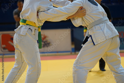 Brazilian jiujitsu fighters in a fight stand up wrestling at the tournament BJJ