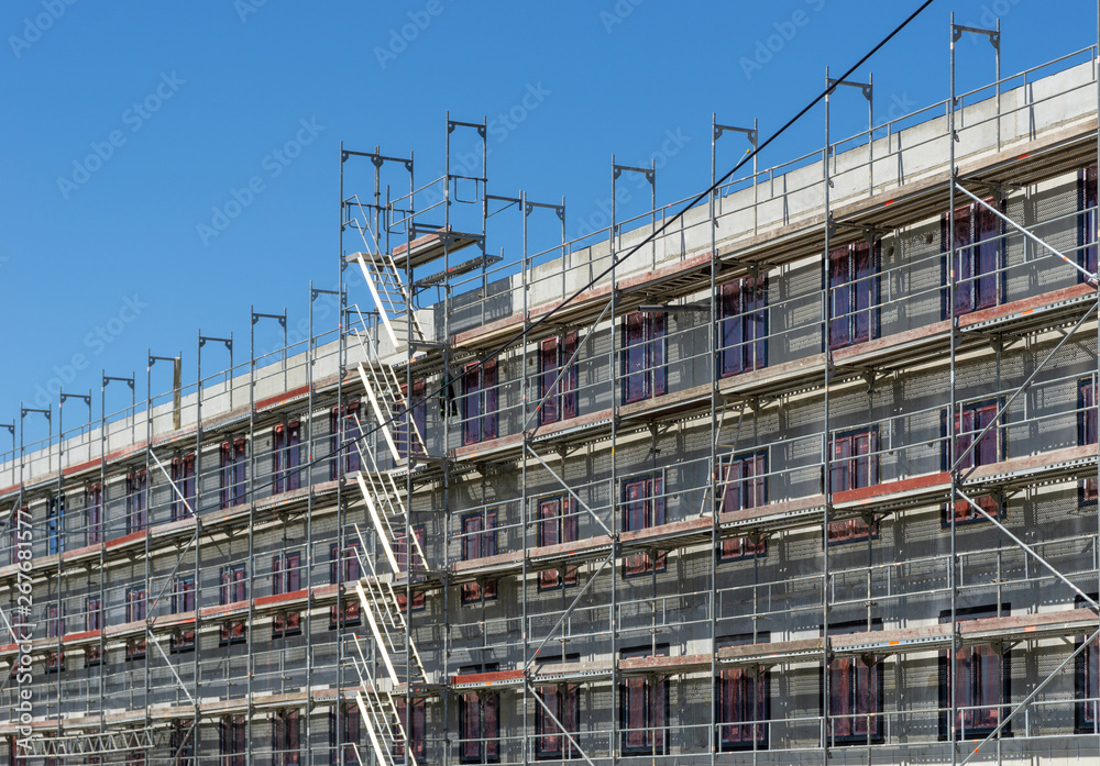 building under construction - facade with scaffolding