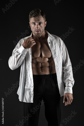 sexy man in unbuttoned shirt. macho man with muscular body. athletic body. male fashion and charisma. brutal sexuality. seducing you. confident macho. man with muscular torso. desire and temptation © be free
