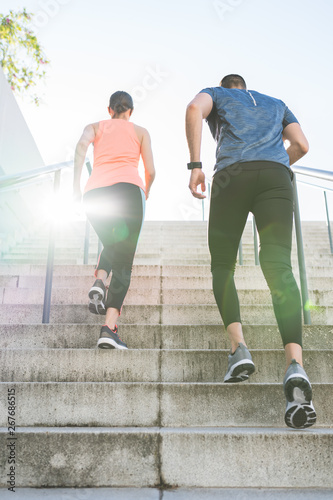 Hispanic Couple Running or Jogging Together Outdoors.