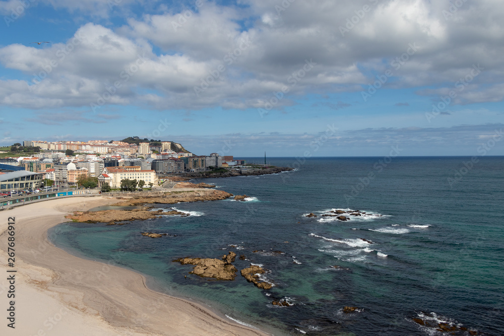 Nice view of the beach of Riazor in A Coruña, Galicia with the buildings of the city and the promenade.