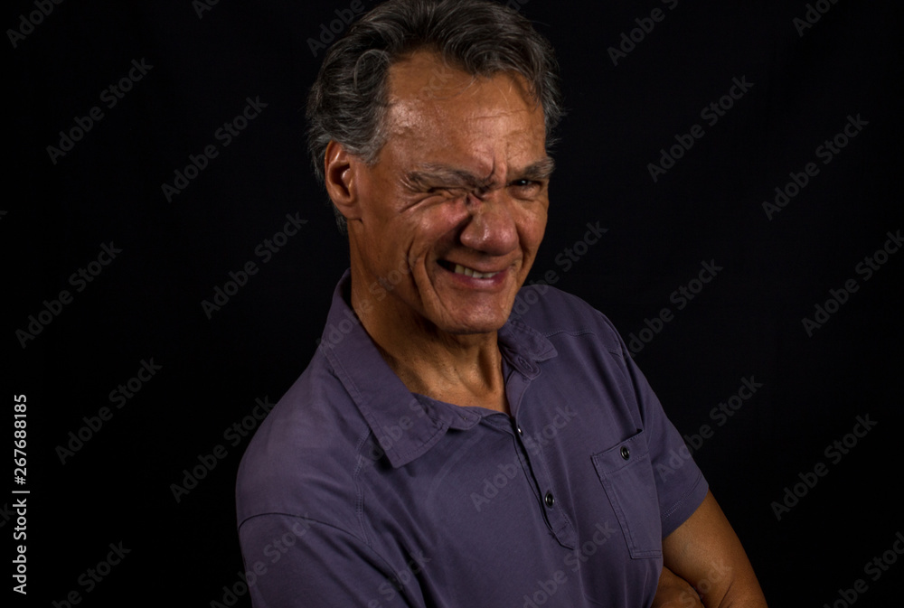 Portrait of a Middle Aged Mature Man Aganist a Black Background