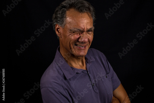 Portrait of a Middle Aged Mature Man Aganist a Black Background