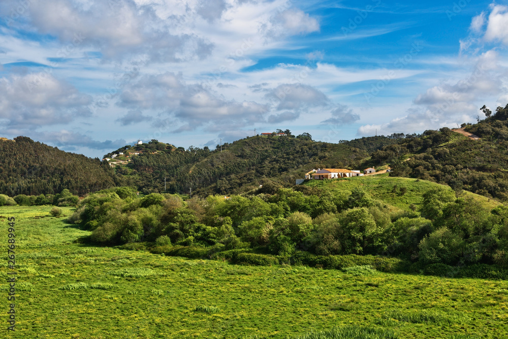 Countryside landscape with rustic houses on hills. Algarve. Portugal.