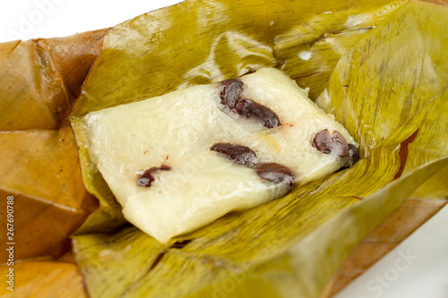 Show inside of Bananas with Sticky Rice (Khao Tom Mat or Khao Tom Pad in thai). Native Thai desert wrapped with banana leaves and then steamed isolated on white background.